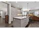 Open concept kitchen featuring a large island, modern cabinets, stainless steel appliances, and seamless flow into living area at 10359 E Los Lagos Vista Ave, Mesa, AZ 85209