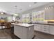 Bright and spacious kitchen with an island, stainless steel appliances, and easy access to the living area at 10359 E Los Lagos Vista Ave, Mesa, AZ 85209