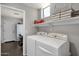 Bright laundry room featuring modern appliances, shelving, and stylish decor at 10359 E Los Lagos Vista Ave, Mesa, AZ 85209