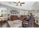 Open-concept living room featuring a plush sofa, natural light, and hardwood floors at 10359 E Los Lagos Vista Ave, Mesa, AZ 85209