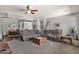 Spacious living room with sectional sofa, coffee table, and seamless access to dining area at 10359 E Los Lagos Vista Ave, Mesa, AZ 85209