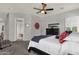 Spacious main bedroom with ceiling fan, carpet flooring, and comfortable furnishings at 10359 E Los Lagos Vista Ave, Mesa, AZ 85209
