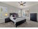 Bedroom featuring large windows, a ceiling fan, and dark furniture, offering a relaxing retreat at 10359 E Los Lagos Vista Ave, Mesa, AZ 85209