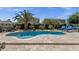 Blue backyard pool with custom stone landscaping and a view of the backyard at 10359 E Los Lagos Vista Ave, Mesa, AZ 85209