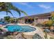 Blue backyard pool with patio, outdoor kitchen, and lush landscaping, perfect for entertaining at 10359 E Los Lagos Vista Ave, Mesa, AZ 85209