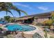 Blue backyard pool with patio, outdoor kitchen, and lush landscaping, perfect for entertaining at 10359 E Los Lagos Vista Ave, Mesa, AZ 85209