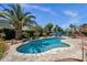 Beautiful blue pool with custom stone landscaping and a view of the backyard at 10359 E Los Lagos Vista Ave, Mesa, AZ 85209