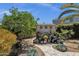 Backyard shed adorned with desert floral decor and surrounded by pottery and desert plants at 10359 E Los Lagos Vista Ave, Mesa, AZ 85209