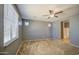 Bedroom featuring neutral colored walls and carpet flooring, ceiling fan, and bright windows at 10548 W Crown King Rd, Tolleson, AZ 85353