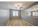 Open loft space with neutral-toned walls, carpet flooring, a ceiling fan, and a window, for extra living space at 10548 W Crown King Rd, Tolleson, AZ 85353