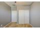 Neutral bedroom featuring a closet with sliding doors, carpet, and gray walls at 10548 W Crown King Rd, Tolleson, AZ 85353