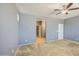 Neutral bedroom with ceiling fan and hallway view to a large closet at 10548 W Crown King Rd, Tolleson, AZ 85353