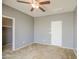 Bedroom featuring a ceiling fan and gray walls, carpet and two doors at 10548 W Crown King Rd, Tolleson, AZ 85353