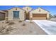 Inviting single-level home featuring a classic design, a two-car garage, and low-maintenance desert landscaping at 10548 W Crown King Rd, Tolleson, AZ 85353