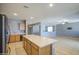 Bright, open kitchen featuring a center island, modern appliances, and spacious tile flooring at 10548 W Crown King Rd, Tolleson, AZ 85353