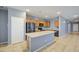 Modern kitchen boasting stainless steel appliances, an island, and tile flooring, perfect for cooking and entertaining at 10548 W Crown King Rd, Tolleson, AZ 85353
