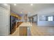 Bright, open kitchen with stainless steel appliances and center island with extended countertop seating at 10548 W Crown King Rd, Tolleson, AZ 85353