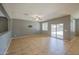 Spacious living room with a ceiling fan, tile floors, and glass patio door at 10548 W Crown King Rd, Tolleson, AZ 85353