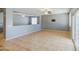Open living room with tile floors, ceiling fan, and lots of natural light from sliding glass door at 10548 W Crown King Rd, Tolleson, AZ 85353