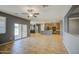 Bright living room with tile floors, kitchen view, and access to the patio through sliding glass doors at 10548 W Crown King Rd, Tolleson, AZ 85353