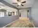 Living room with gray walls, carpet flooring, and partial wall features, showcasing the spacious and bright living space at 10548 W Crown King Rd, Tolleson, AZ 85353