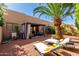 Spacious backyard features a covered patio, chaise lounges, and mature landscaping for outdoor enjoyment at 10863 N 117Th Pl, Scottsdale, AZ 85259