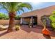 Expansive backyard with covered patio, lounge chairs, lush foliage, and desert landscaping at 10863 N 117Th Pl, Scottsdale, AZ 85259