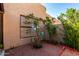 Backyard area features a garden bed with decorative details and mature flowering bushes at 10863 N 117Th Pl, Scottsdale, AZ 85259