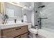 Modern bathroom with wood vanity, sleek fixtures, walk-in shower with glass door and white tiles at 10863 N 117Th Pl, Scottsdale, AZ 85259
