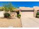 Charming single-story home with a two-car garage, desert landscaping and a cozy front entrance at 10863 N 117Th Pl, Scottsdale, AZ 85259