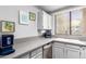 Efficient kitchen design with stainless steel appliances and modern grey countertops at 10863 N 117Th Pl, Scottsdale, AZ 85259