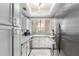 Well-lit kitchen with sleek stainless steel appliances and modern white cabinetry at 10863 N 117Th Pl, Scottsdale, AZ 85259