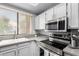 Well lit kitchen with modern stainless steel appliances, undermount sink, and bright white cabinets at 10863 N 117Th Pl, Scottsdale, AZ 85259