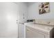 Laundry room with white appliances and white walls at 10863 N 117Th Pl, Scottsdale, AZ 85259
