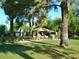 Relax in this backyard featuring a gazebo and many shade trees at 11141 W Cameo Dr, Sun City, AZ 85351