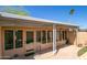 Covered patio with glass doors and desert landscaping at 11141 W Cameo Dr, Sun City, AZ 85351