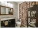 Stylish bathroom with decorative tiles, vanity sink, and shower at 11141 W Cameo Dr, Sun City, AZ 85351