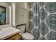 Charming bathroom featuring vanity, commode, mirror and colorful shower curtain at 11141 W Cameo Dr, Sun City, AZ 85351