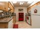 Well lit kitchen features stainless steel sink, tile countertops and backsplash at 11141 W Cameo Dr, Sun City, AZ 85351