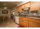 View of kitchen with double sink and breakfast area beyond at 11141 W Cameo Dr, Sun City, AZ 85351