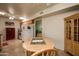 Eat-in kitchen features natural wood cabinets, tile floor and white appliances at 11141 W Cameo Dr, Sun City, AZ 85351