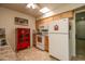 Galley kitchen features white appliances, tile countertops and natural wood cabinets at 11141 W Cameo Dr, Sun City, AZ 85351