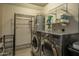 Well-equipped laundry room with modern washer and dryer and ample storage at 11141 W Cameo Dr, Sun City, AZ 85351