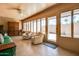 Sunroom offering backyard access, tile floors, bright walls, and comfortable chairs at 11141 W Cameo Dr, Sun City, AZ 85351