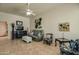 Living room with ceiling fan, neutral paint, tile flooring and comfortable furnishings at 11141 W Cameo Dr, Sun City, AZ 85351