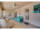 Bright sunroom featuring tile floors, a ceiling fan, and comfortable seating at 11141 W Cameo Dr, Sun City, AZ 85351