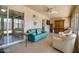 Relaxing sunroom with comfortable chairs, tile floors, and outdoor access at 11141 W Cameo Dr, Sun City, AZ 85351