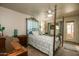 Comfortable primary bedroom featuring a four-poster bed, with windows and access to the patio at 11141 W Cameo Dr, Sun City, AZ 85351