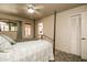 Bright main bedroom with a four-poster bed, outside patio views, and a convenient bathroom entrance at 11141 W Cameo Dr, Sun City, AZ 85351