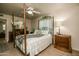 The well-lit primary bedroom includes a decorative bed frame and views into the ensuite bathroom at 11141 W Cameo Dr, Sun City, AZ 85351